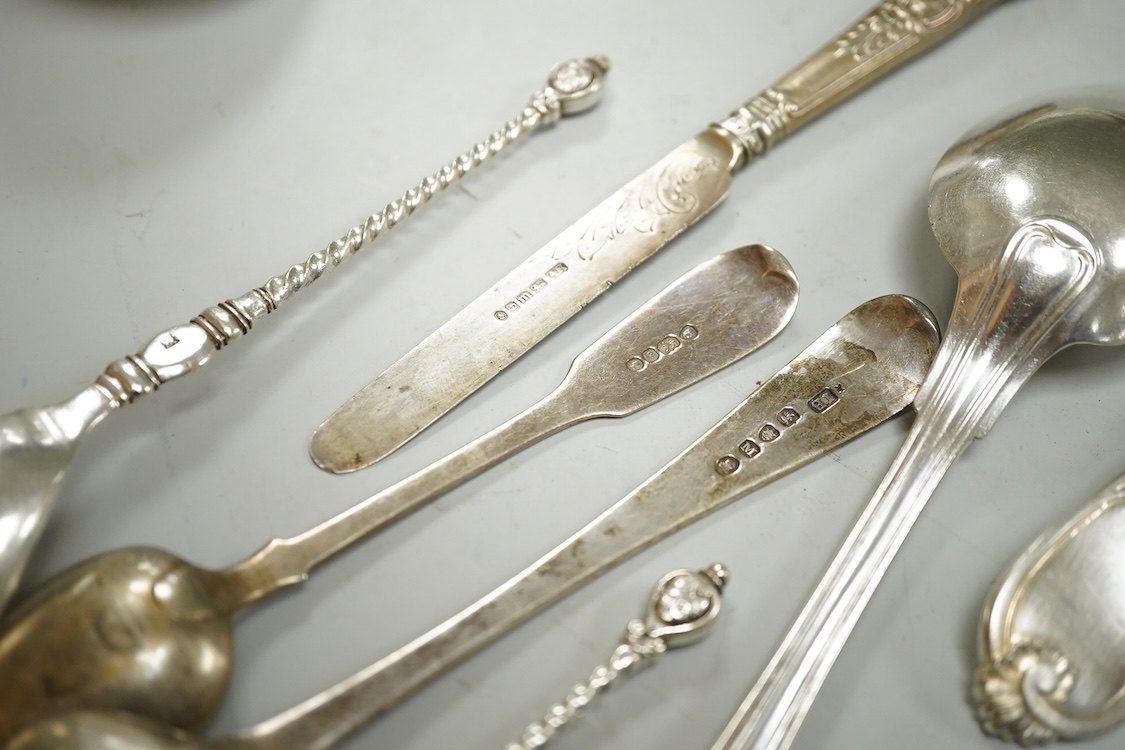 A George III silver Old English pattern dessert spoon, London, 1807, a later silver teaspoon and ten other items of white metal cutlery including a soup ladle, German tablespoon, pair of sugar tongs etc.